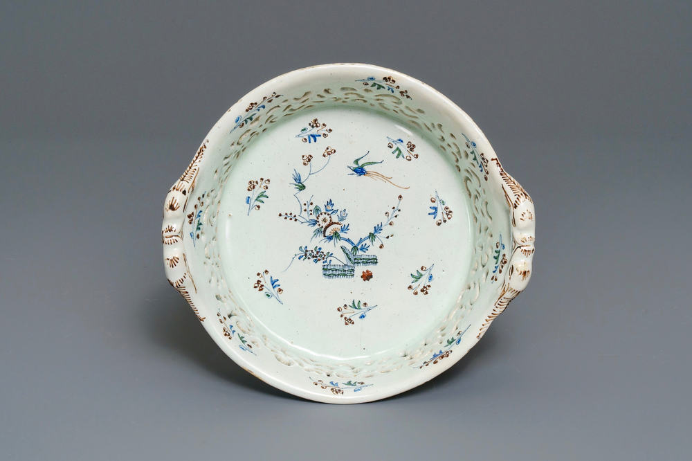 A polychrome Brussels faience '&agrave; la haie fleurie' reticulated basket, 18th C.